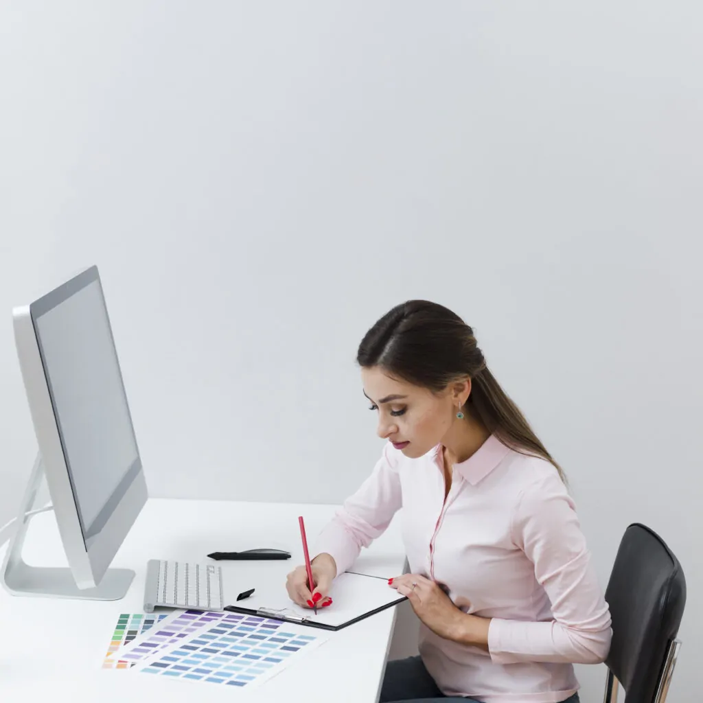 side view woman writing something down while desk branding